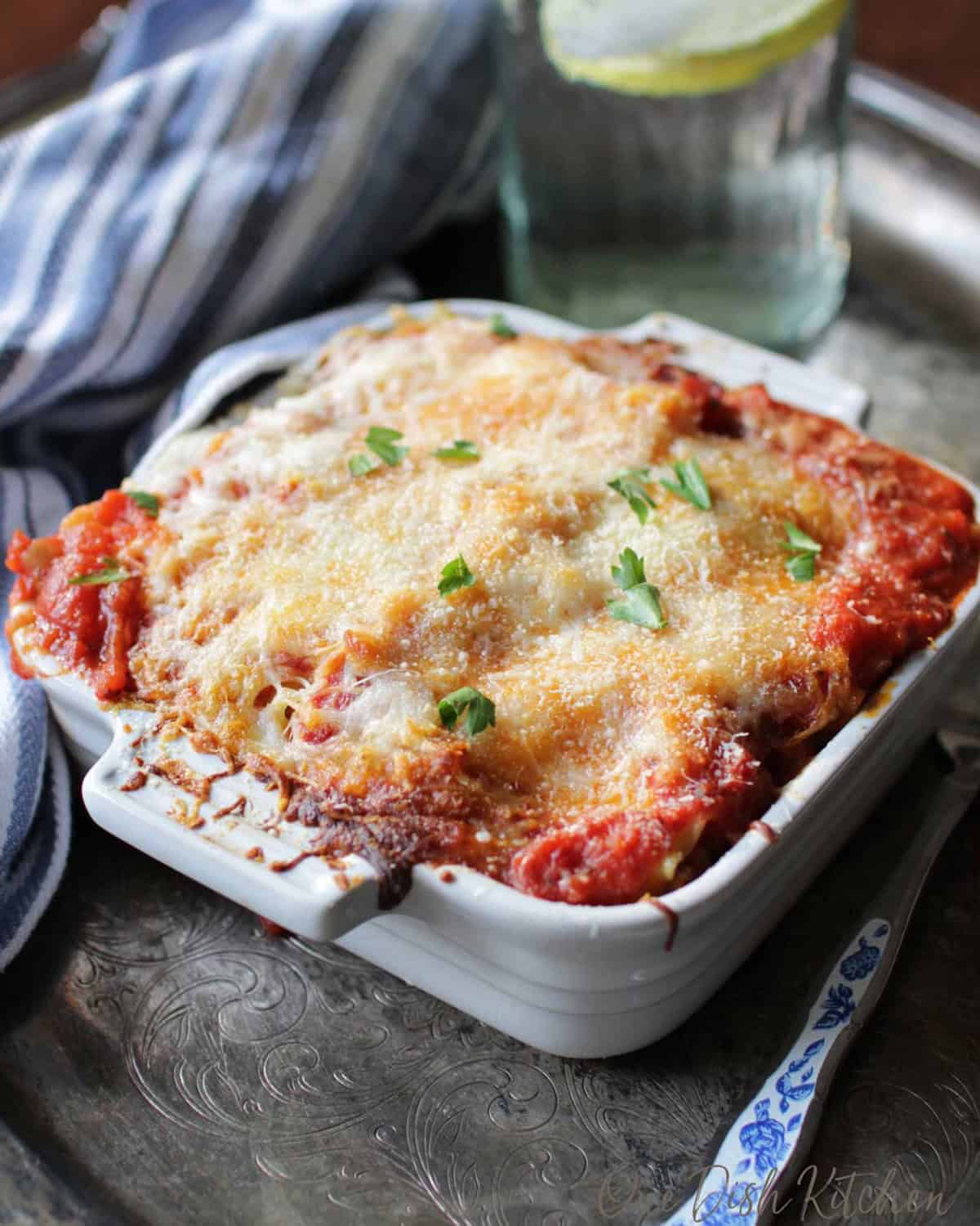 baked lasagna in a square baking dish.