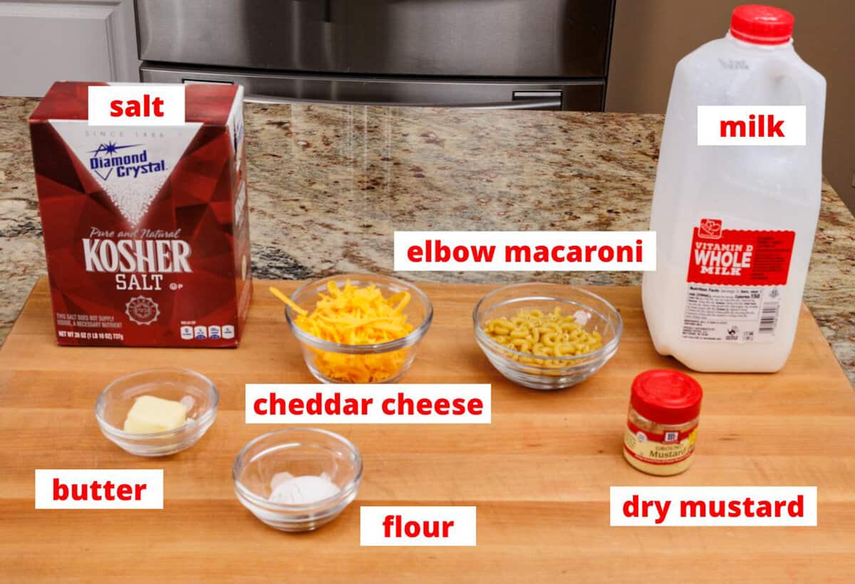 macaroni and cheese ingredients on a wooden cutting board