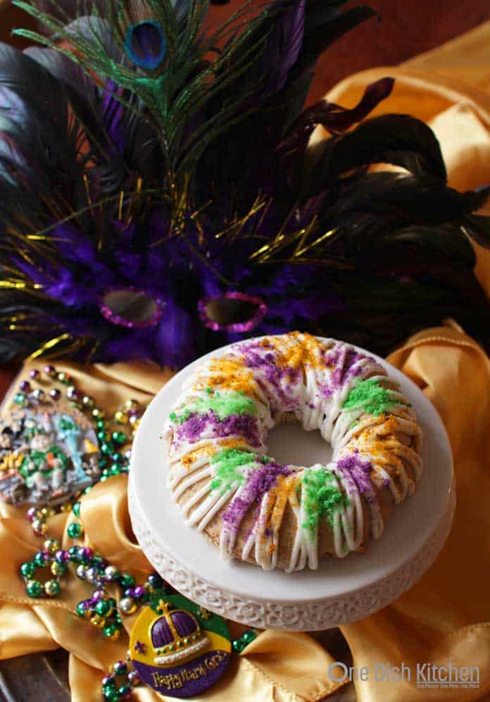 king cake surrounded by mardi gras beads | one dish kitchen