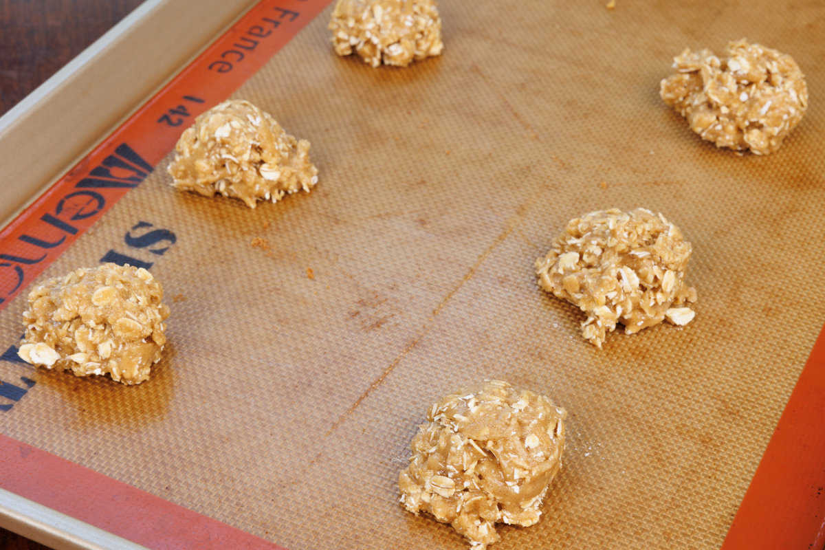 unbaked oatmeal cookies on a baking sheet