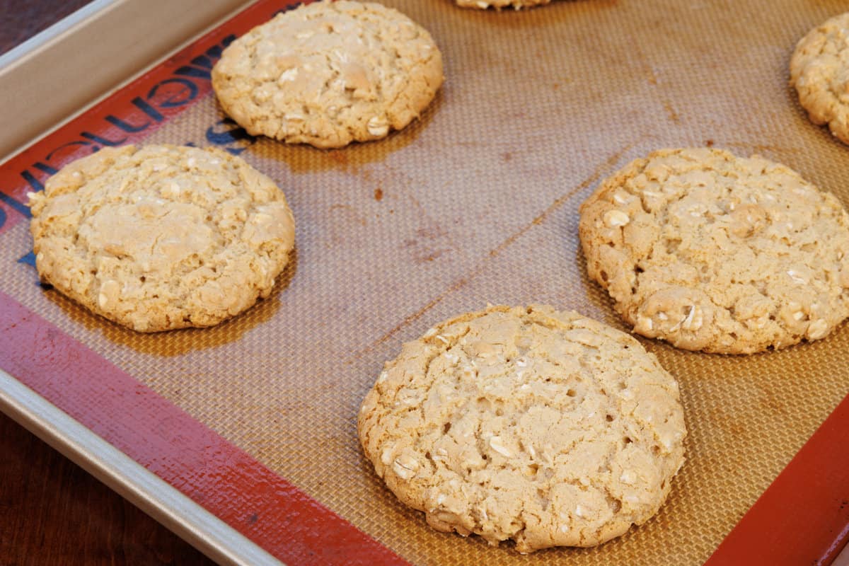 six oatmeal cookies on a cookie sheet