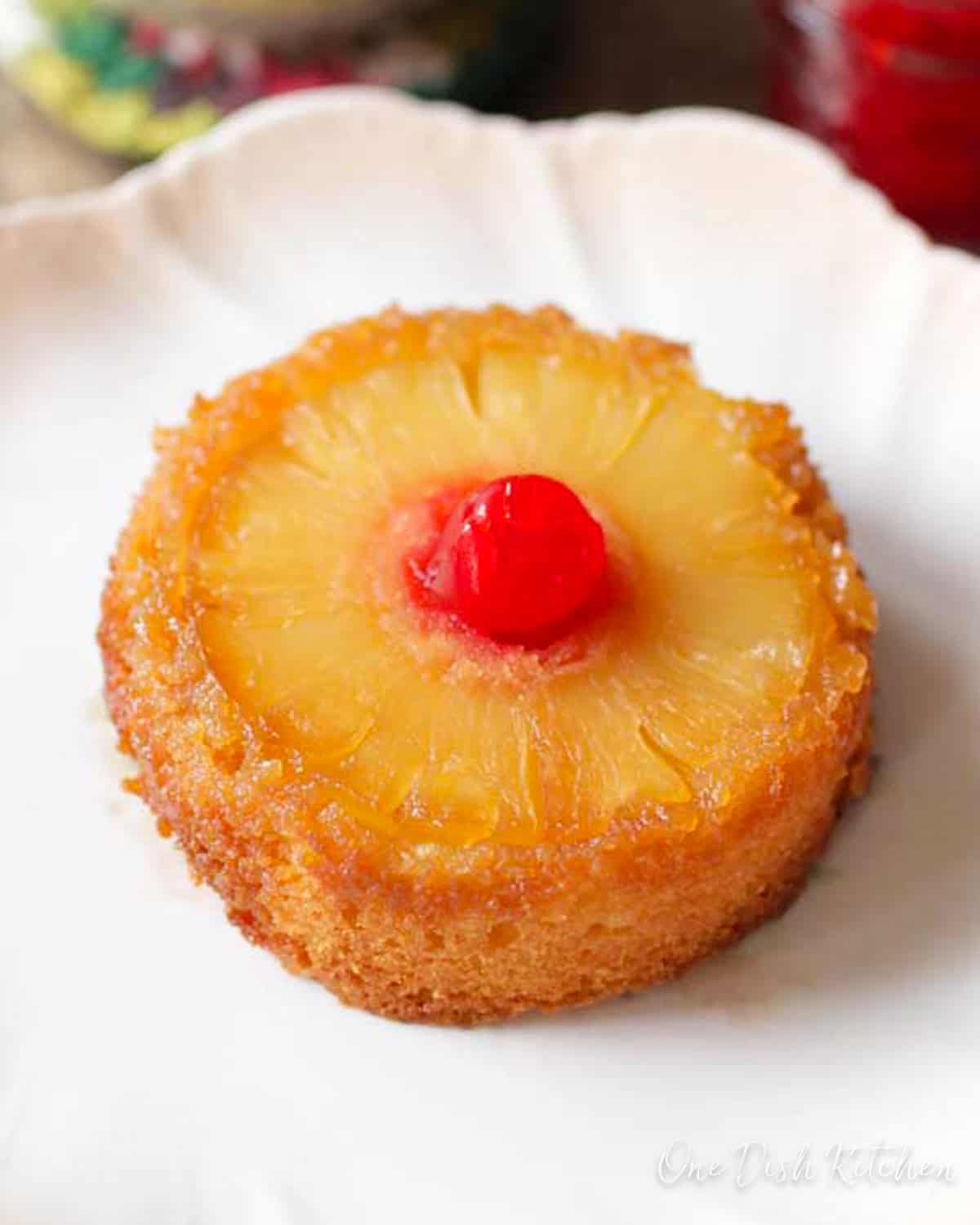 a mini pineapple upside down cake on a white plate.