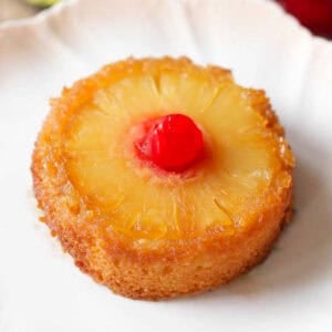 a mini pineapple upside down cake on a white plate.