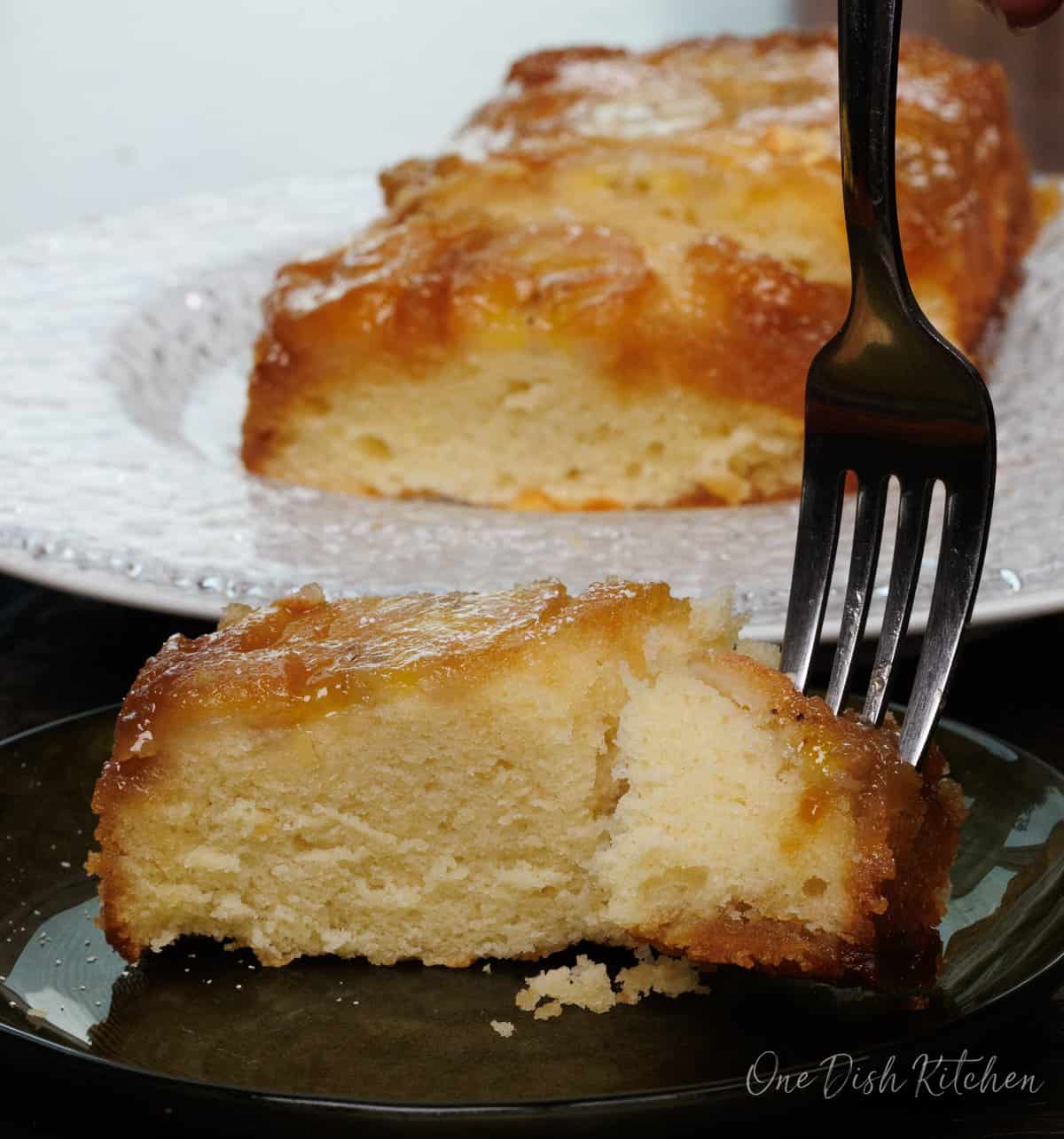 a fork in a caramelized banana upside down cake.