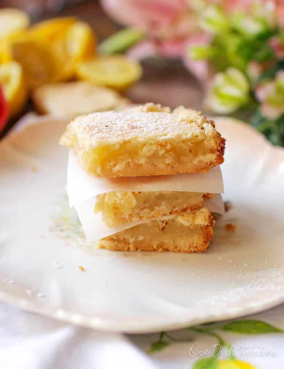 three lemon bars stacked on top of each other.