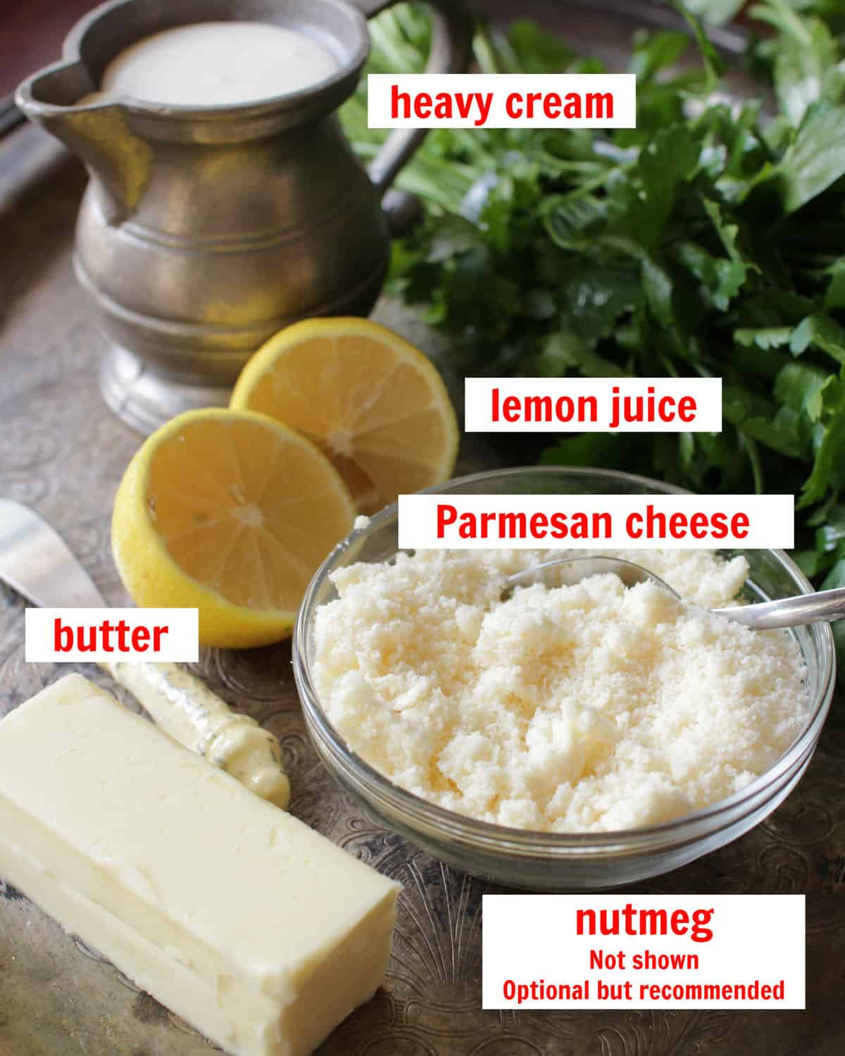 ingredients in alfredo sauce on a silver tray