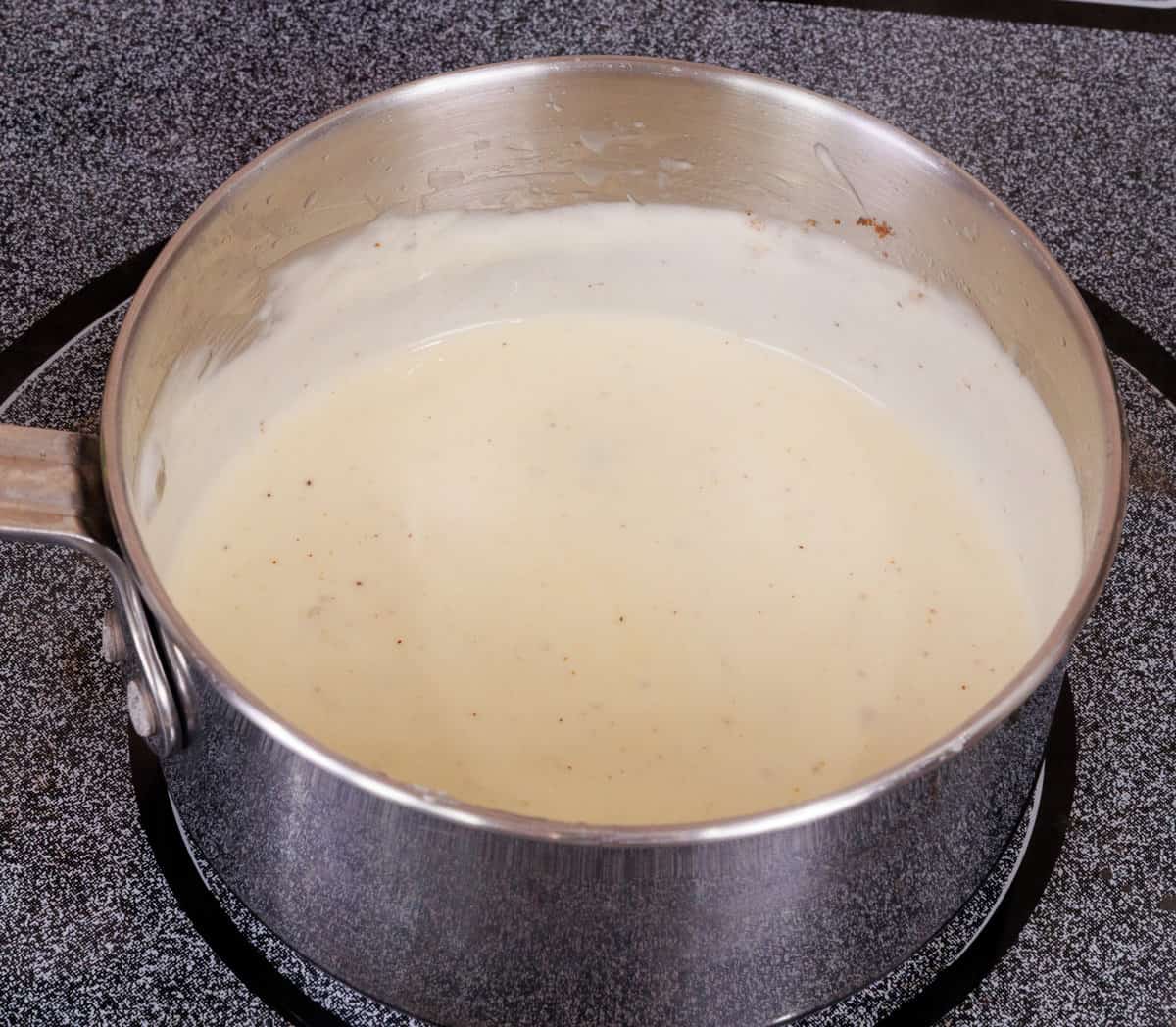 alfredo sauce cooking on a stove