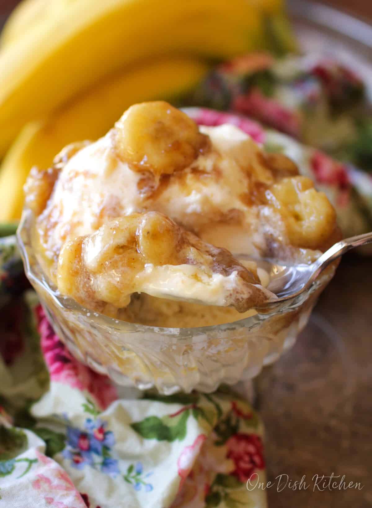 bananas foster over ice cream in a small dessert dish