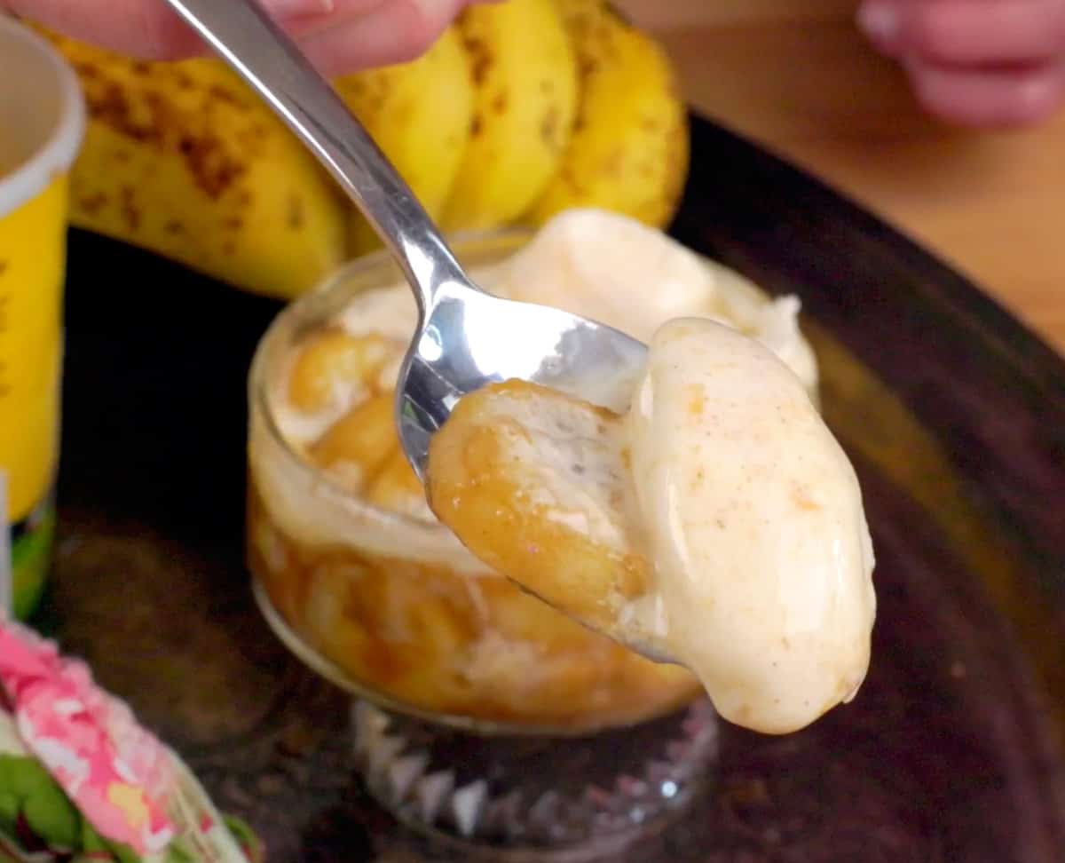 bananas foster in a dessert dish on a silver tray.