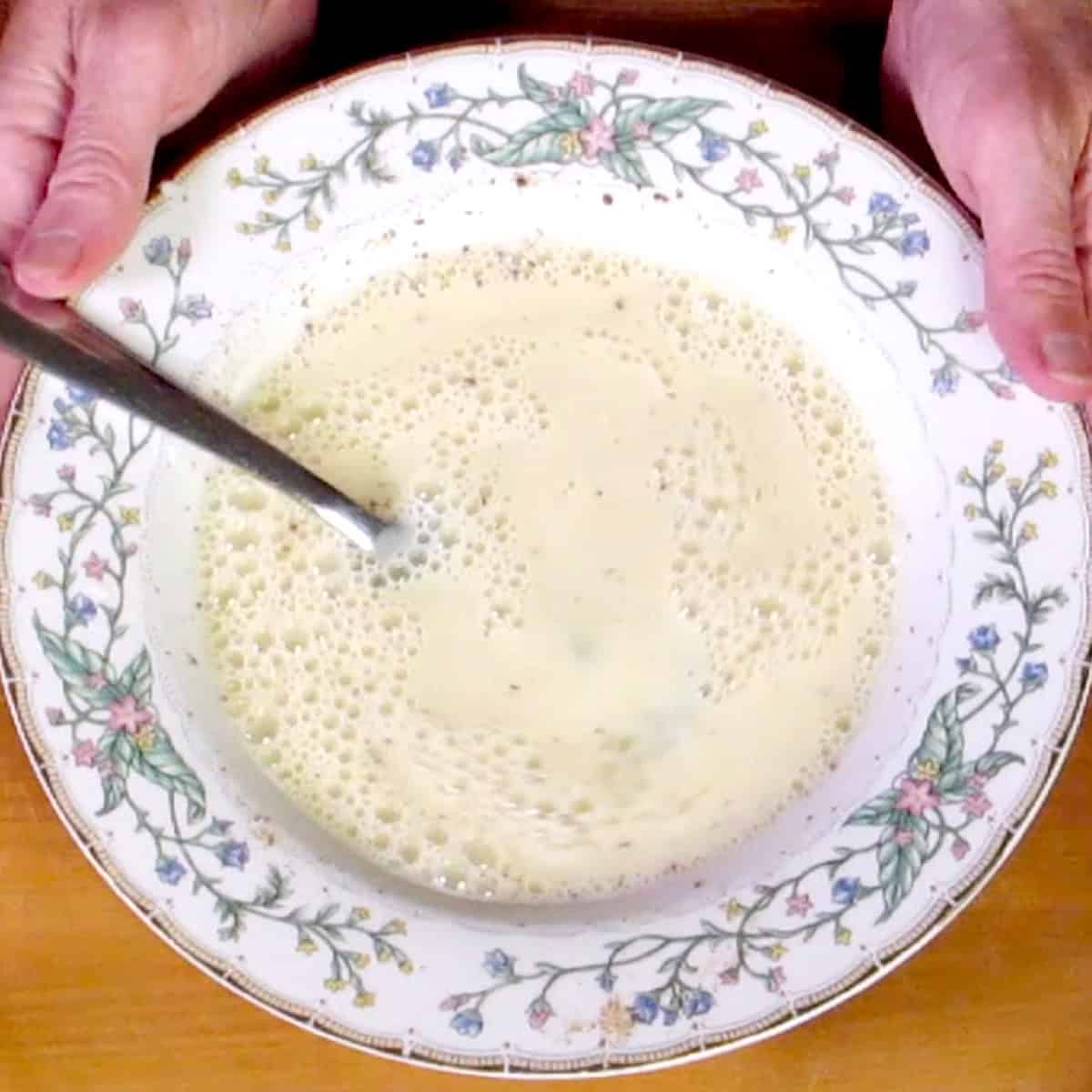 milk, egg, and spices mixed together in a bowl.