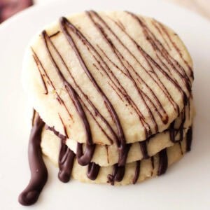 three shortbread cookies on a white plate.