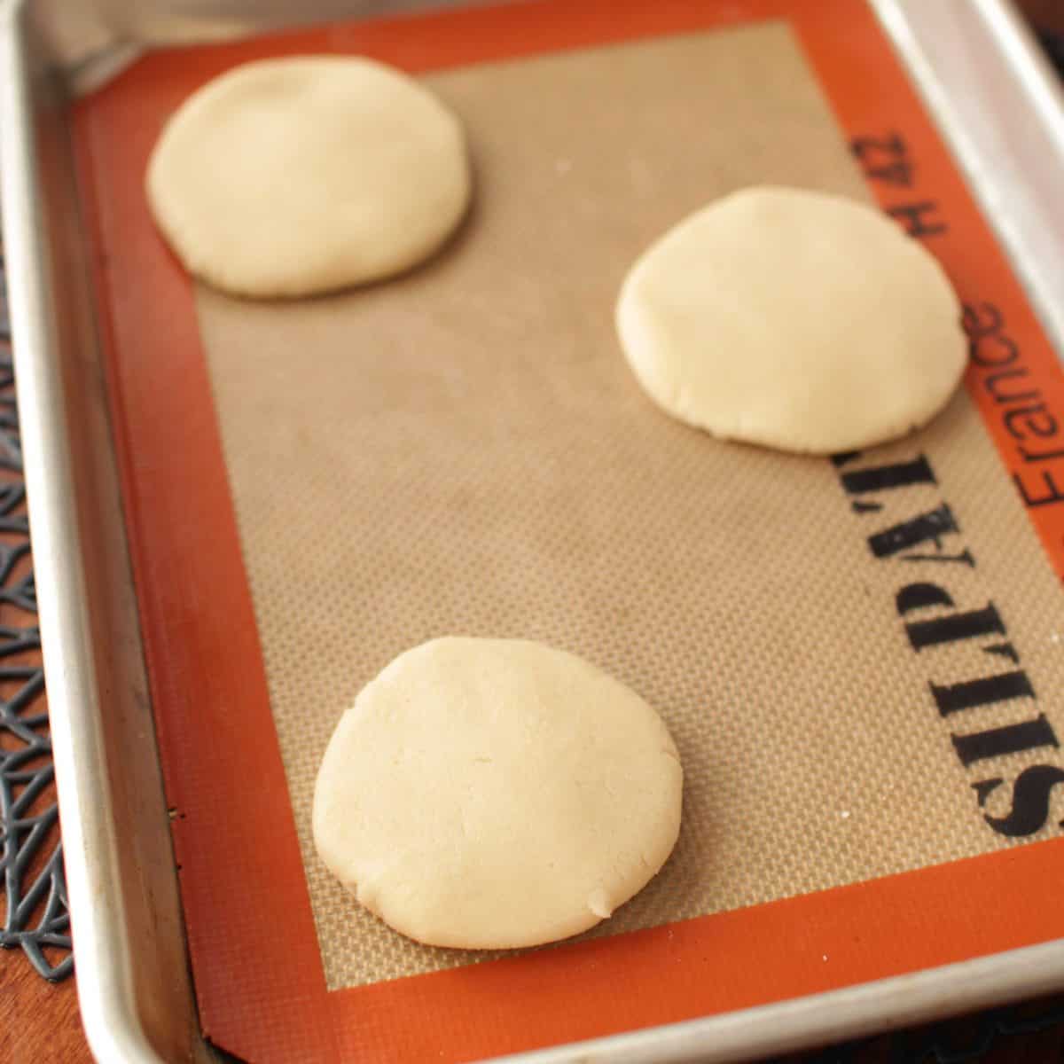 shortbread cookie dough flattened on a baking sheet.