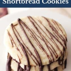 three shortbread cookies drizzled with melted chocolate stacked on top of each other.