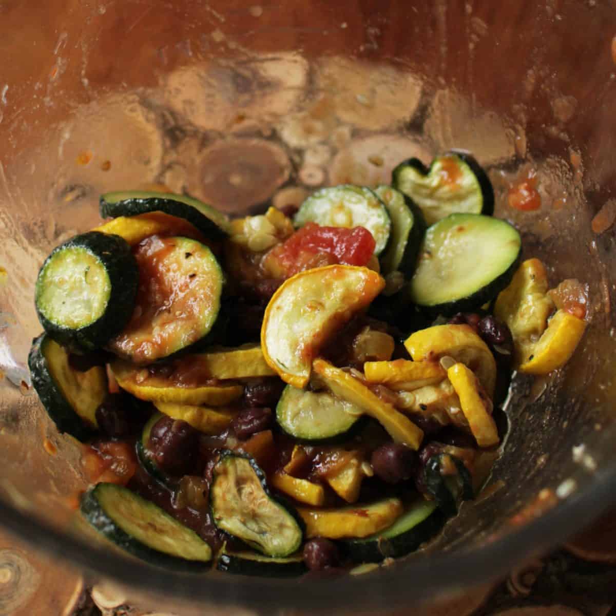 a bowl of cooked summer squash and zucchini.