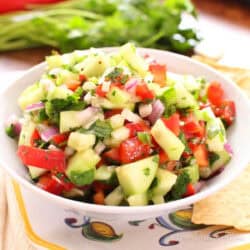 Small batch cucumber salsa made with chopped cucumbers, red onion, bell pepper, cilantro, and lime juice in a serving bowl.