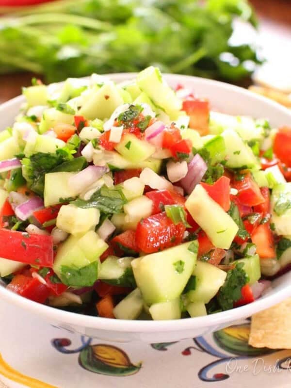Small batch cucumber salsa made with chopped cucumbers, red onion, bell pepper, cilantro, and lime juice in a serving bowl.