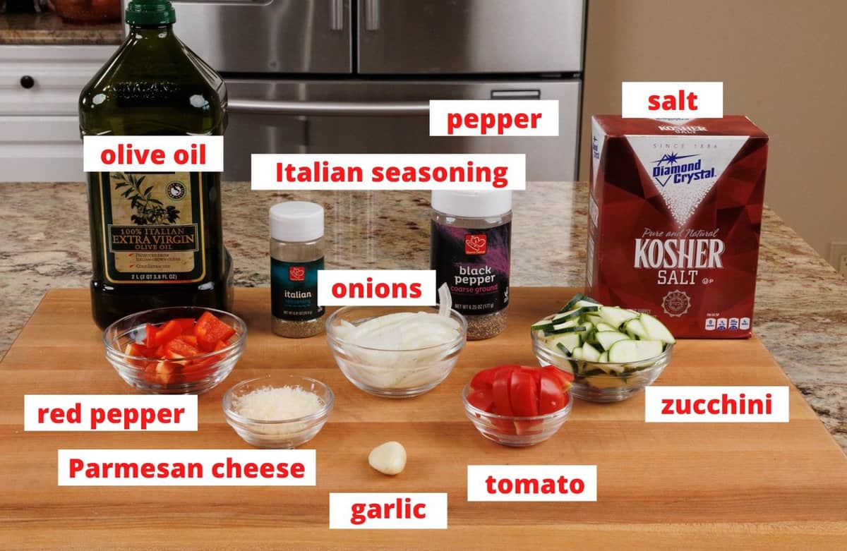 ingredients in ratatouille on a wooden cutting board.