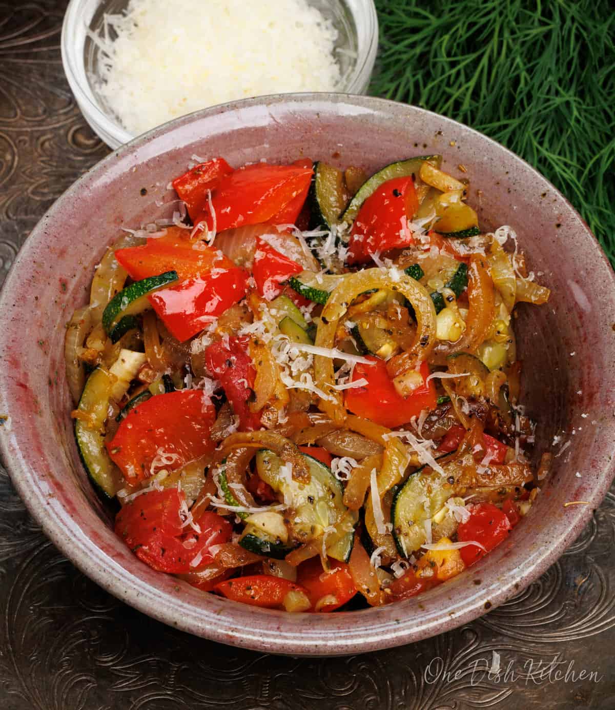 an overhead picture of a bowl of French ratatouille on a silver tray.