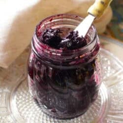 a jar of jam on a kitchen table.