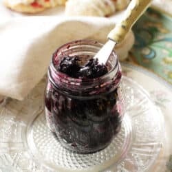 a jar of jam on a kitchen table.
