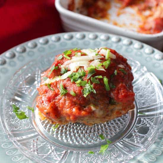 single meatball with tomato sauce and cheese on top