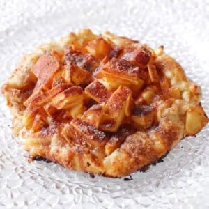 a small apple galette on a white plate.