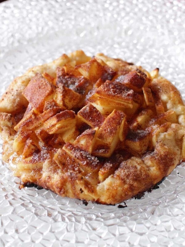 a mini apple galette on a white plate