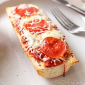 a single serving french bread pizza topped with pepperoni and mozzarella cheese.