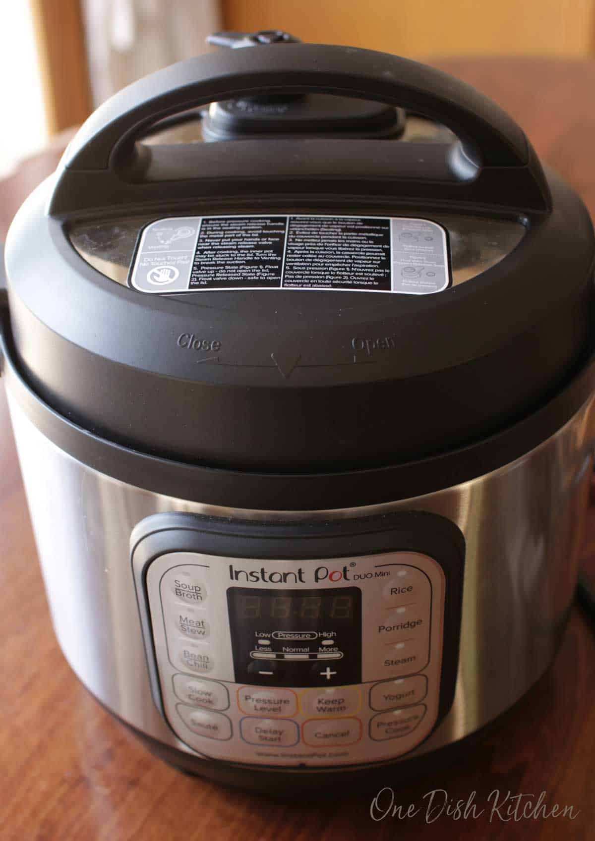 An instant pot closed with sweet potatoes inside.
