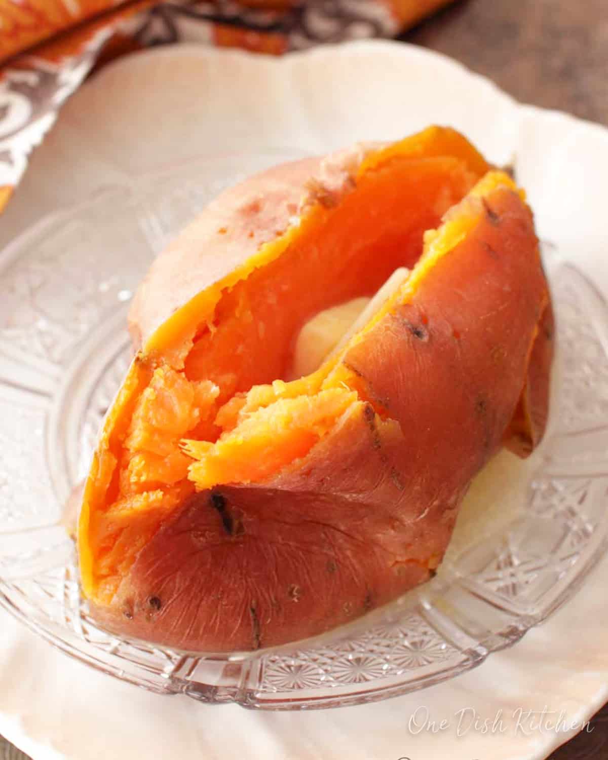 an instant pot sweet potato on a white plate.