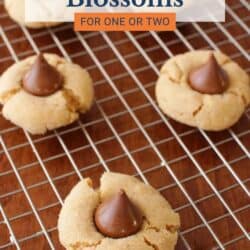 5 peanut butter blossom cookies on a cooling rack.