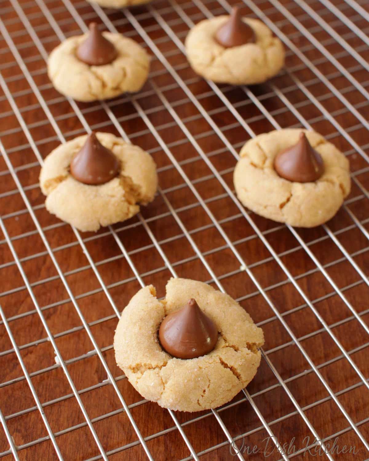 a small batch of peanut butter blossoms on a cooling rack.