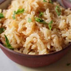 a brown bowl filled with rice pilaf.