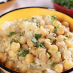 chickpea curry covering rice in yellow bowl - pinterest promo pin image