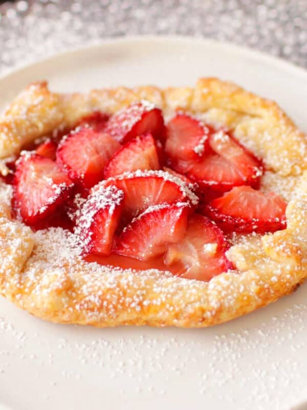 a small strawberry galette made with a mini pie crust and topped with strawberries.