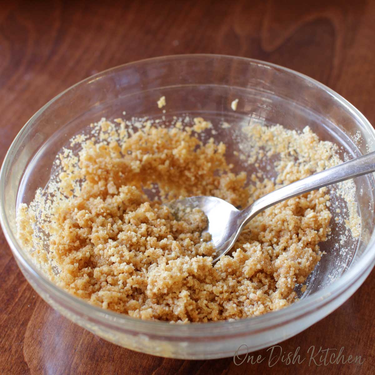 Graham cracker crumbs in a bowl with a spoon.