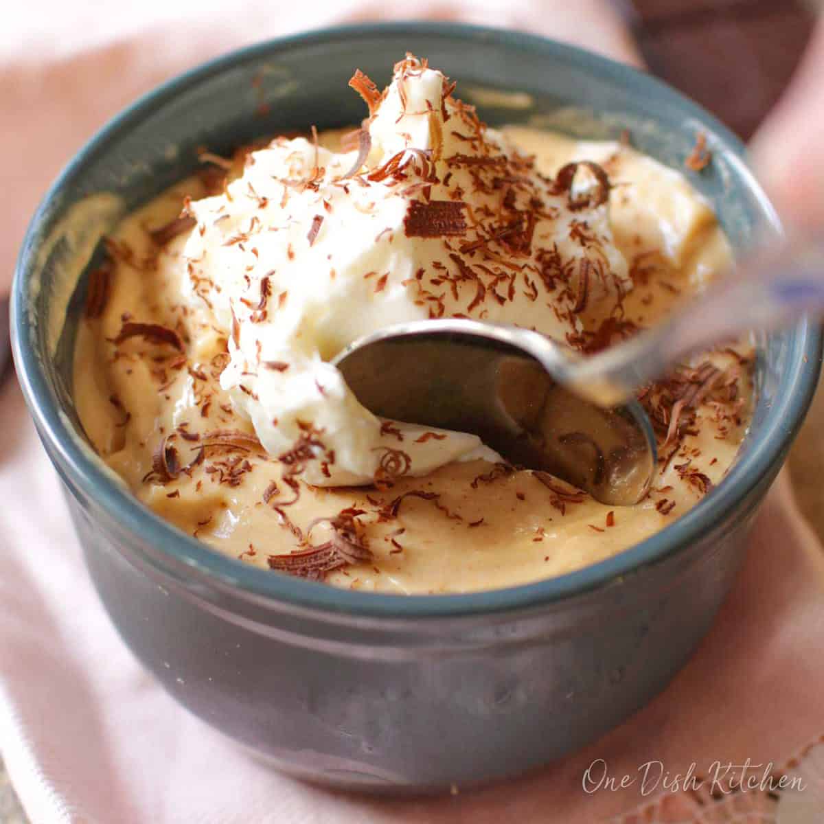 a small peanut butter pie with a spoon on the side of the dish.