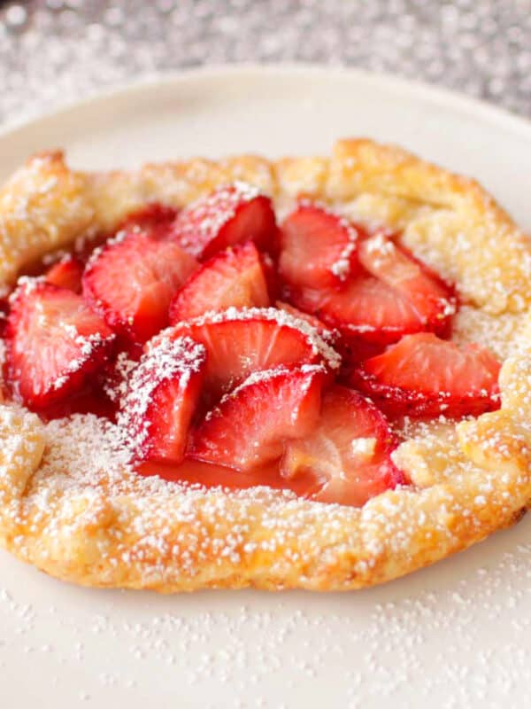 a strawberry galette on a white pie plate.