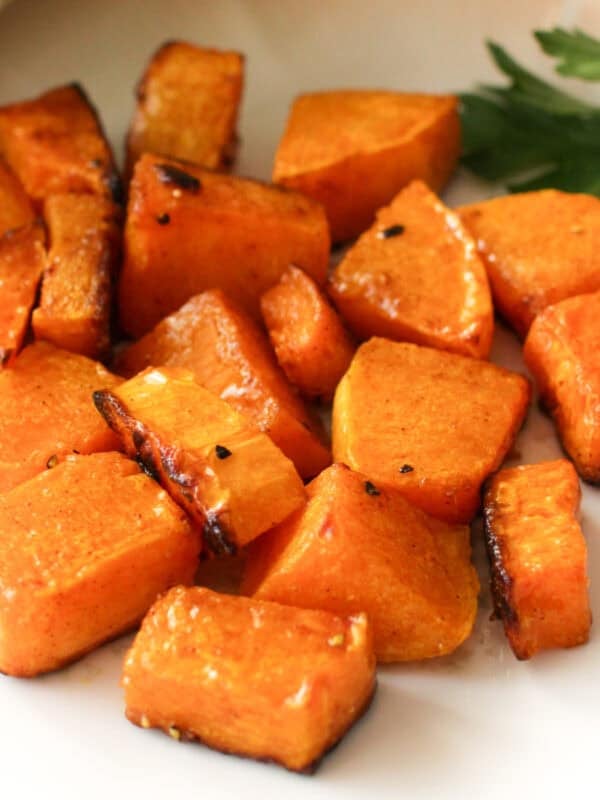 roasted butternut squash on a white plate.