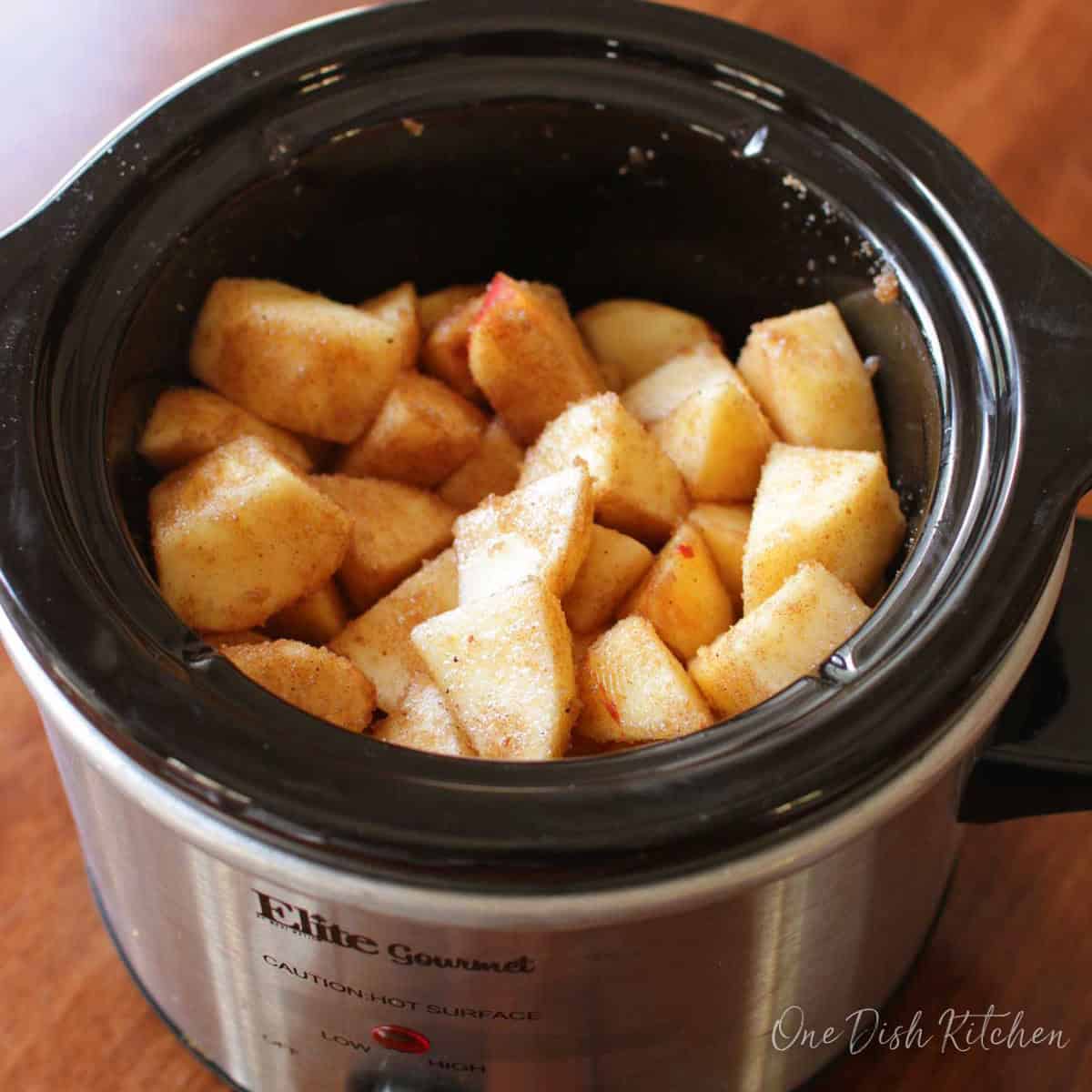 chopped apples and spices in a slow cooker.