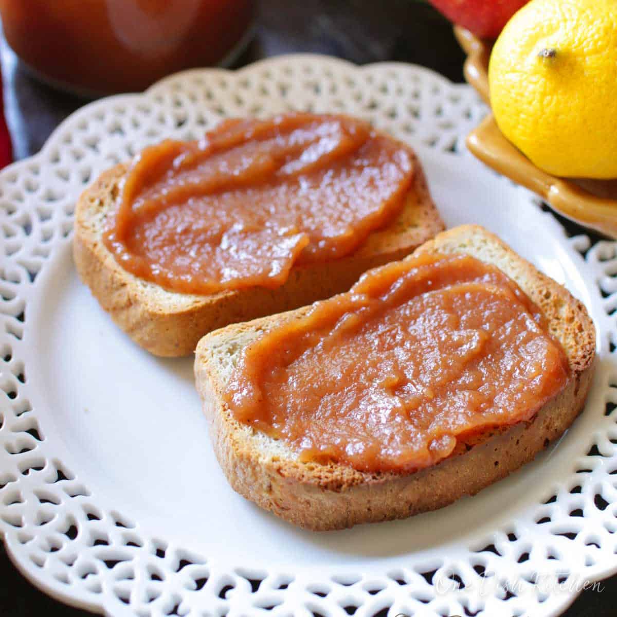 crockpot apple butter spread of slices of toast.