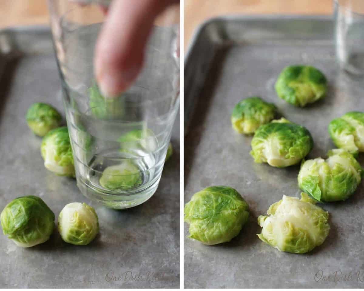smashing a brussels sprout with the bottom of a drinking glass on a baking sheet.
