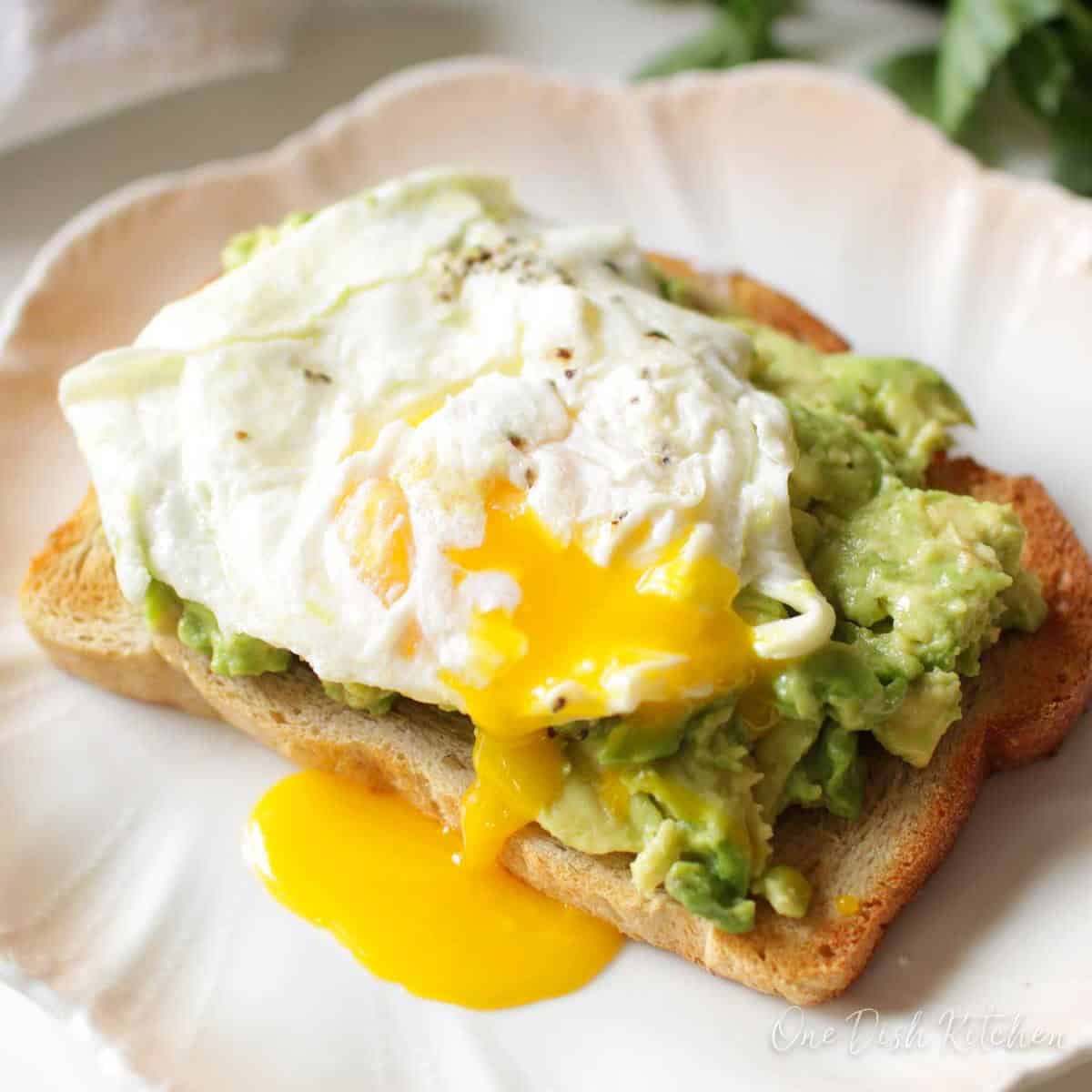 avocado toast with a fried egg on top.