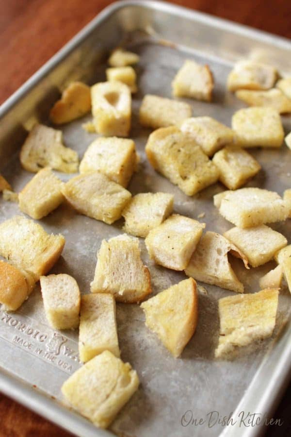 pieces of olive oil soaked bread on a baking sheet