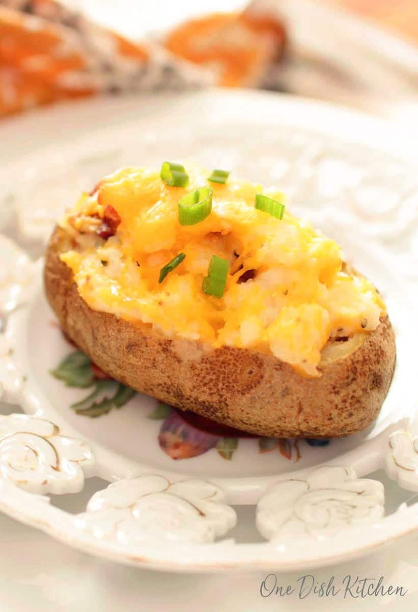 a twice baked potato on a white plate.