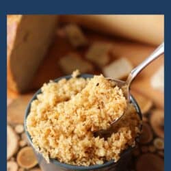 a bowl of homemade breadcrumbs next to a loaf of bread.