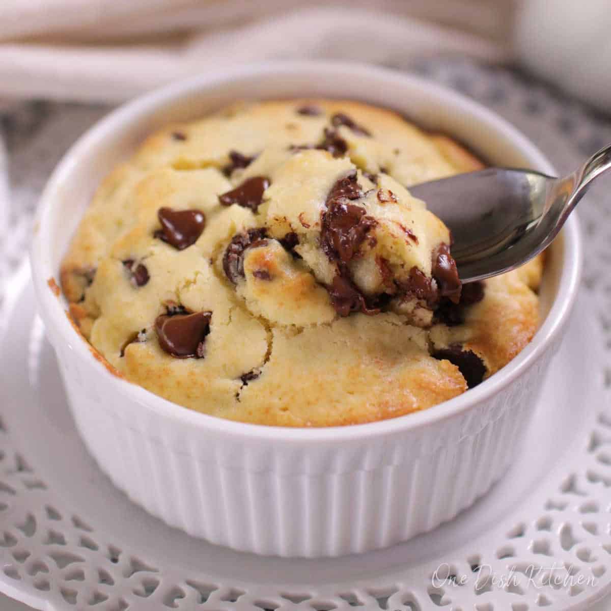 A spoonful of a chocolate chip muffin from a ramekin.
