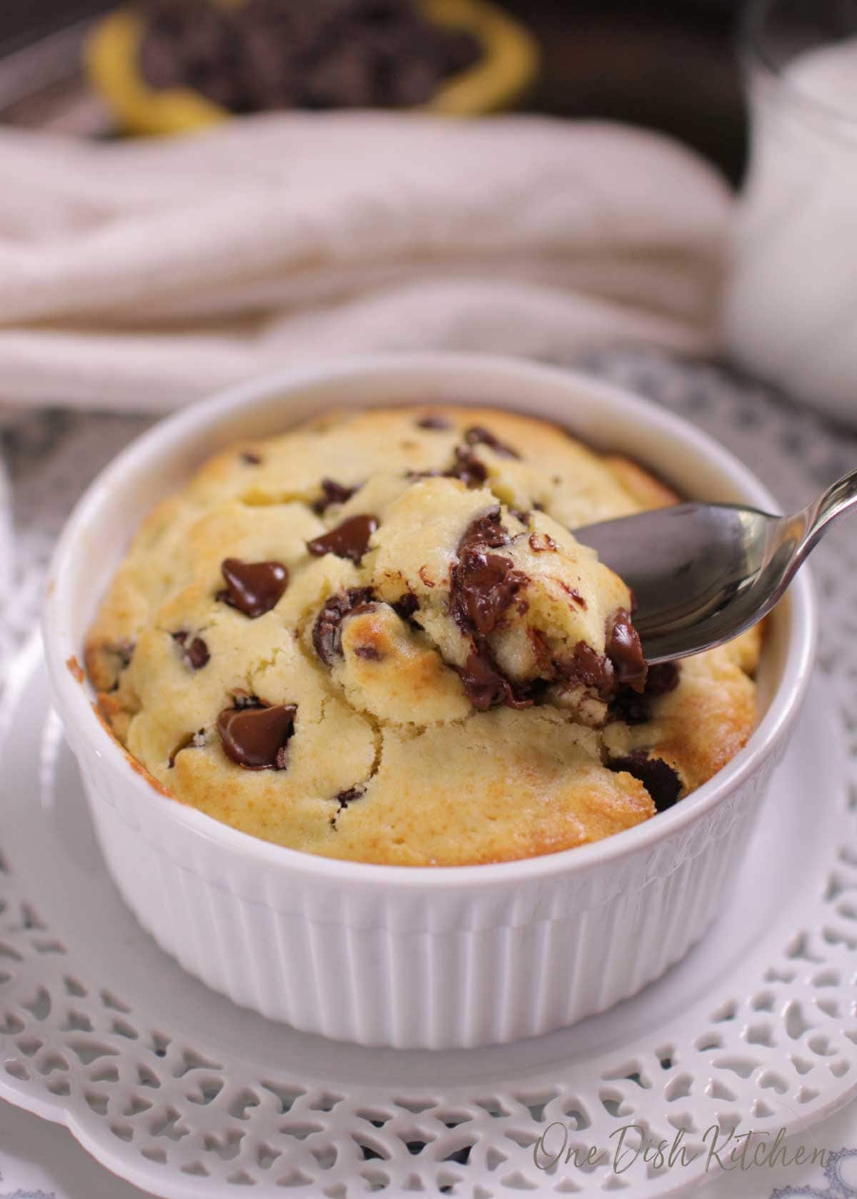 A spoonful of a chocolate chip muffin from a ramekin 