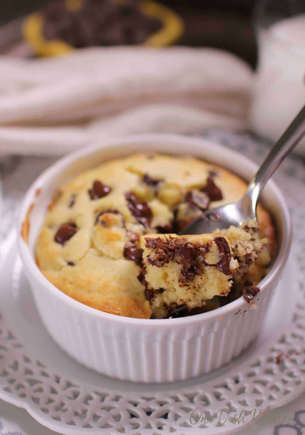 A spoonful of a chocolate chip muffin from a ramekin 