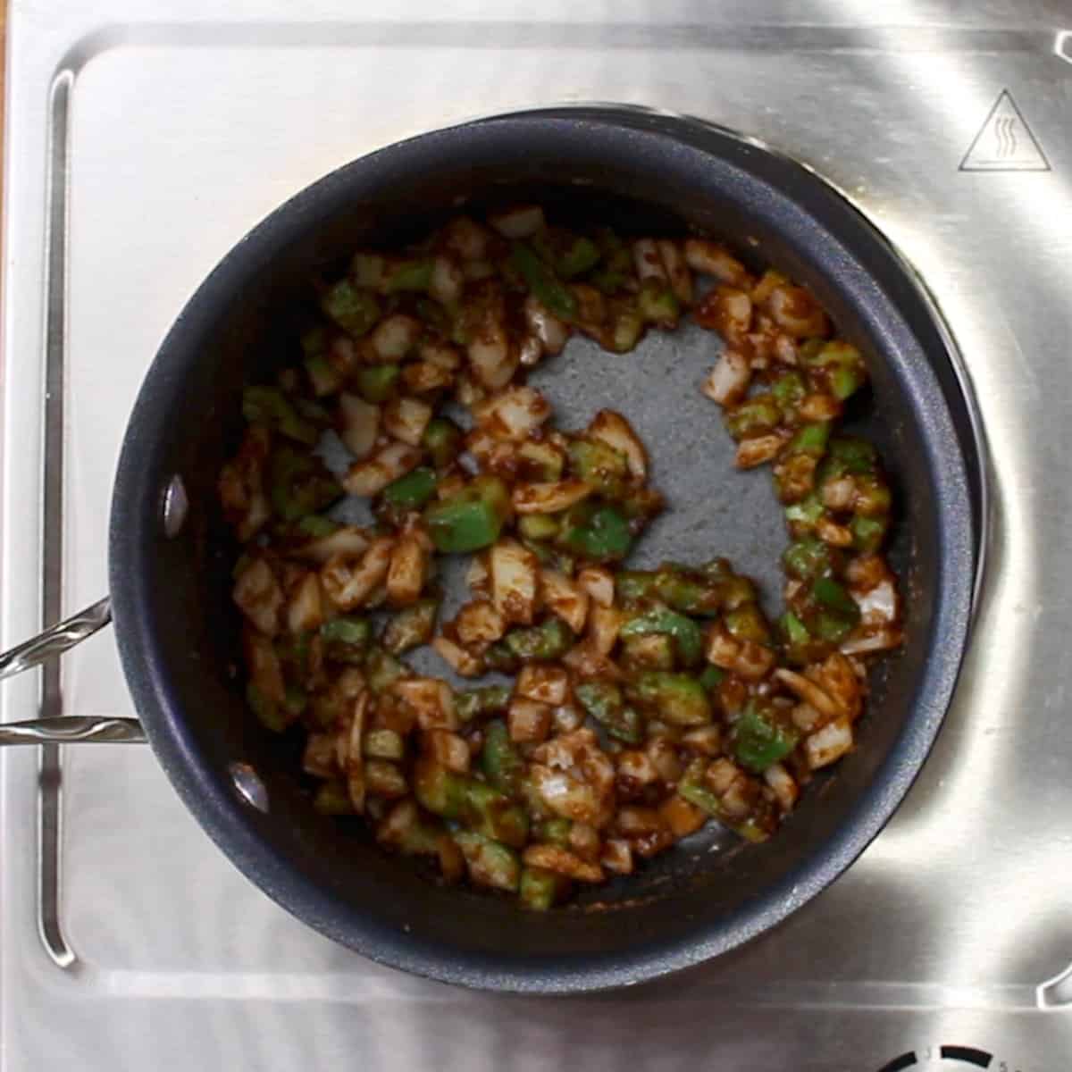 onions, garlic, and bell peppers simmering in roux